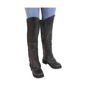 Women’s knee-high black leather half chaps worn over black motorcycle boots.