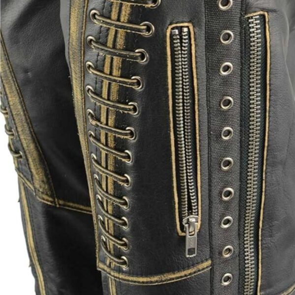 Close-up view of lace and seam detailing on women’s black leather motorcycle chaps.